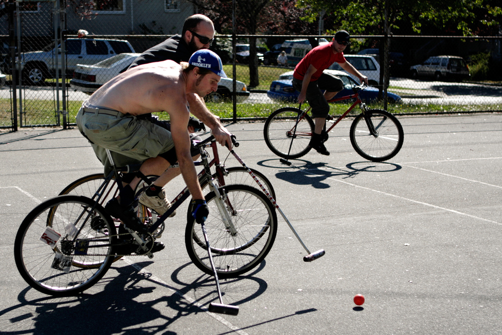 Playing_urban_bike_polo_on_a_hard_tennis_court_in_east_vancouver